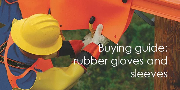 An electrical linesman wears rubber insulating gloves, sleeves and leather outer protectors